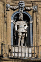 Fototapeta na wymiar Statue of the Spanish king of Sicily Philip III on the facade of the Quattro Canti square built in 1608-20 by Giulio Lasso.