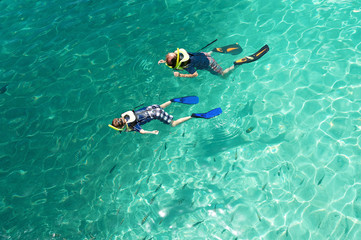 man with sun snorkeling