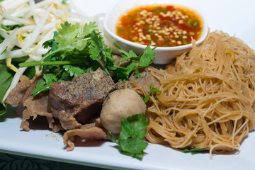 asian noodle soup with beef meatball with fresh vegetable, street food, hot and spicy noodle soup
