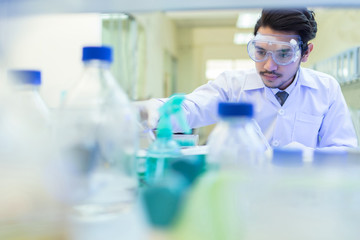 Asian scientist  in the laboratory working at lab with test tube