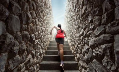 Women are exercising by running up the stairs. - obrazy, fototapety, plakaty
