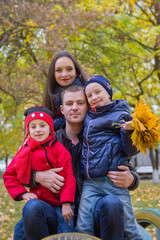 Fototapeta premium Family with two children in autumn park