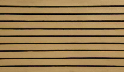 Brown wood siding forms a regular pattern that can be used for backgrounds.