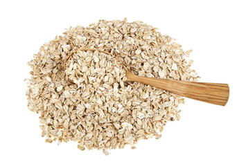 Oat flakes in wooden spoon on white background