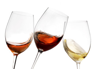 Toasting gesture red and white wine with splash, cheers close up with wine isolated 