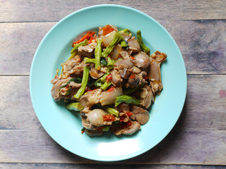 Fried basil leave with chicken innards on plate,spicy