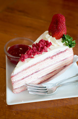 Crepe cake with strawberry sauce on table.selective focus