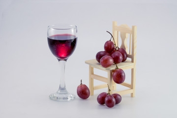 glass of wine and grapes, isolated on white