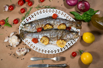 delicious trout fish baked with lemon, tomatoes and spices
