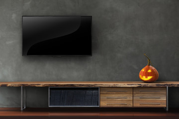 Tv on concrete wall with pumpkin halloween in living room