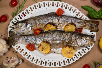 delicious trout fish baked with lemon, tomatoes and spices