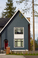 Brand new blue house with red door.