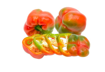 One sliced and two whole bell peppers on light background