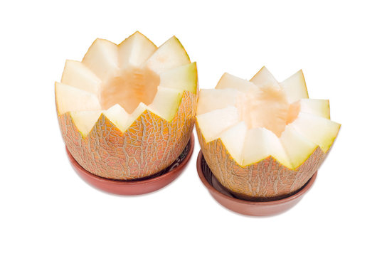 Two halves of melon in ceramic bowls on a light background