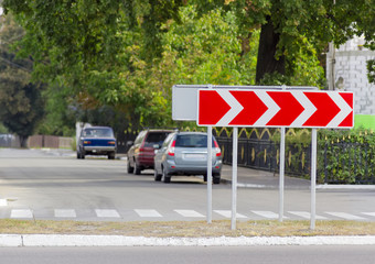 Road sign curve chevrons on a city street
