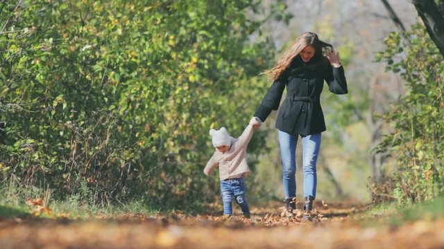 Mother walk with baby outdoor at park