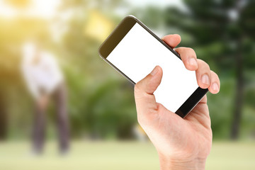 Touch screen in hand, tablet on golf club - soft blur background