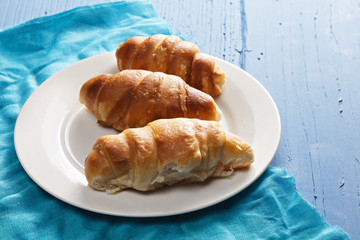 Fresh croissants on plate