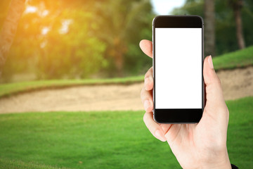 Touch screen in hand, tablet on golf club - soft blur background