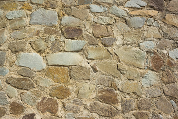 A fragment of a wall. Masonry of natural stone.