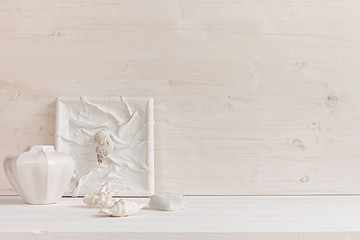 Soft home decor;  shells and corals on white wooden background. Interior.