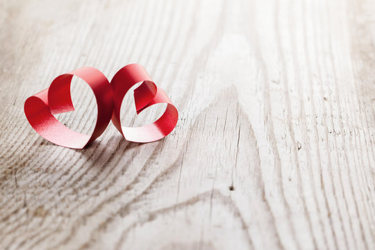 Ribbon hearts on wooden background