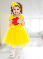 Cute little girl holds heart