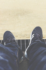 Fototapeta premium Man in blue jean relax sitting on the ground. over light [blur a