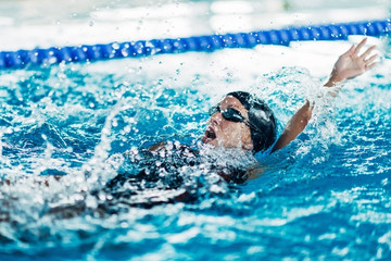 Swimmer. Female swimmer swimming back stroke