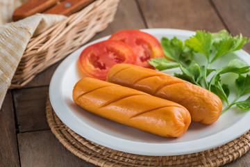 Grilled sausage with vegetables on plate