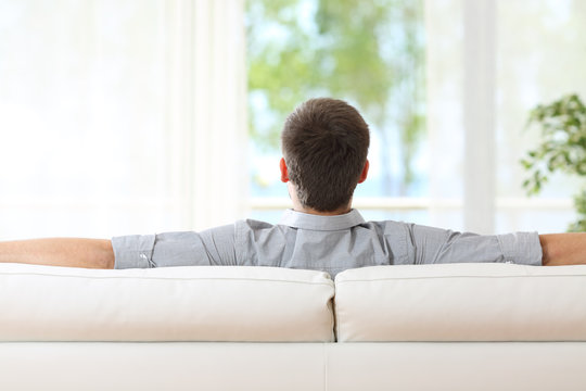 Man relaxing on a couch at home