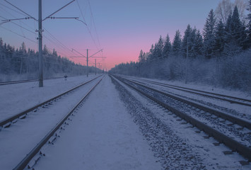 Fototapeta na wymiar Frozen railway road to the twilight