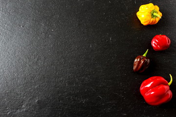 composition of colorful chili peppers on a slate plate