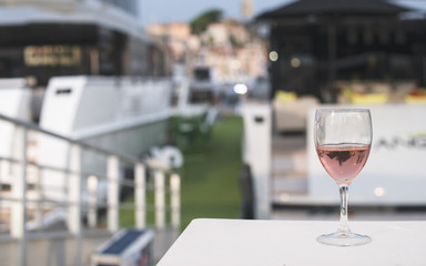 Glass of wine and a yacht