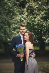 Young beautiful couple, girl with perfect dress posing in park