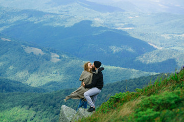 Naklejka na ściany i meble Romantic couple on mountain top