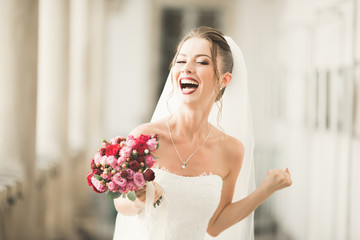 Luxury wedding bride, girl posing and smiling with bouquet