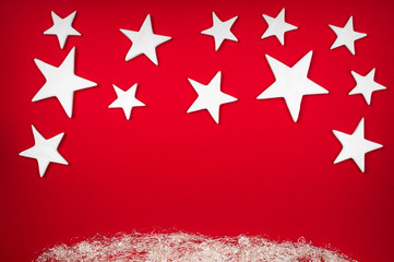 Christmas background - white stars over a red background with silver angel-hair