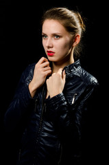 a young girl in a leather jacket