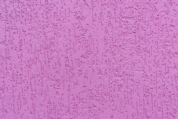 A fragment of a pink wall with decorative plaster