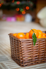 Basket with tangerines. Christmas decor