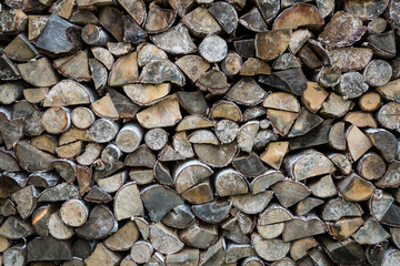 Stacked chopped birch firewood - background.