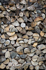 Stacked chopped birch firewood - background.