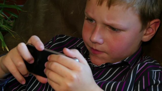 4k Close up of child playing game on smartphone