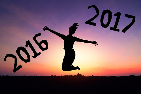 Female jumping silhouette Concept natural light New Year 2017 Sunset background.