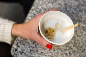 Young woman is drinking coffee 