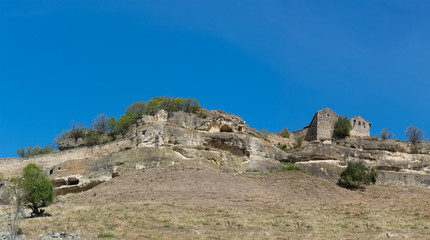 Fototapeta na wymiar View of the cave city-fortress Chufut-Kale from the southern slope and beams Maryam-Dere