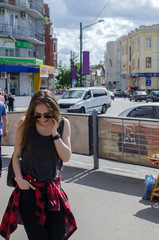 Fototapeta premium Young woman is using her cellphone 