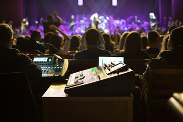 Soundman working on the mixing console.