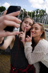 girlfriends are making selfie on the street